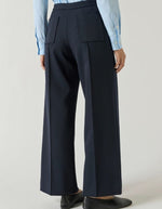 Dos du Pantalon droit légèrement évasé pour femme en lainage bleu marine navy longueur 7/8e avec poches plaquées et pli marqué, modèle Harry de la marque Soeur.
