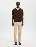 Pantalon Brody Slim Tapered en lin et coton beige porté par un homme.