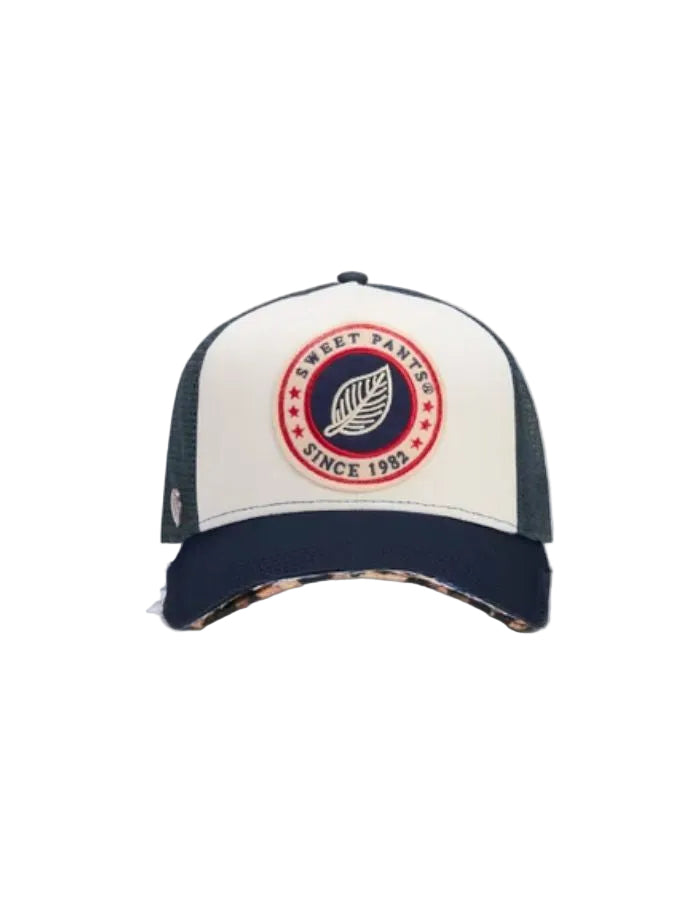Casquette trucker Sweet Pants bicolore bleu marine et blanc avec patch logo feutrine et visière léopard destroy.