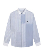 Chemise ample pour homme en popeline de coton à motifs patchwork, modèle Breteuil Patchwork de la marque Maison Labiche. Présente une coupe droite large avec col chemise, boutons gravés et une broderie discrète à l'arrière du col.