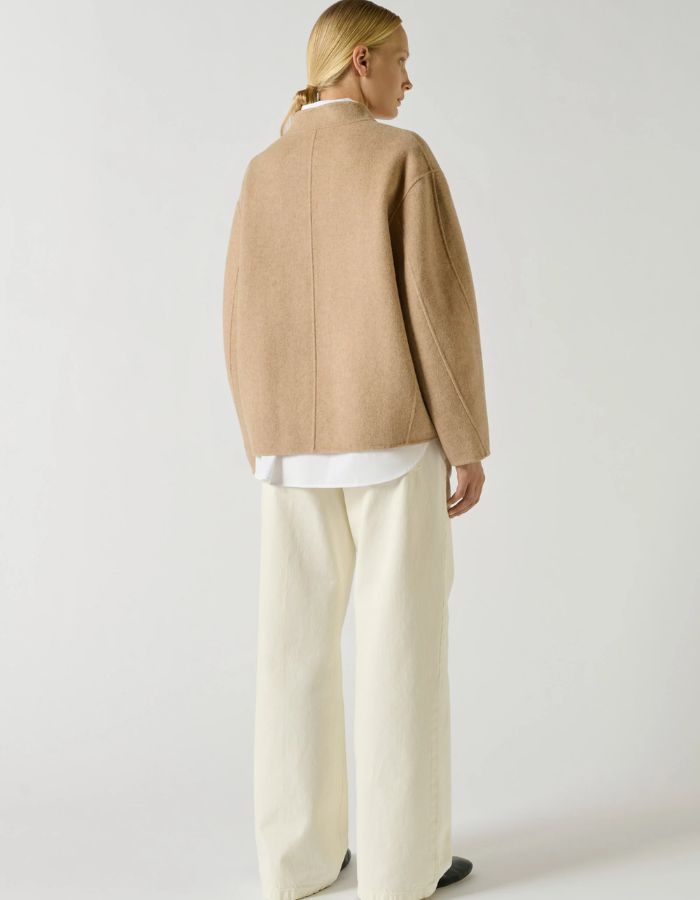 Dos du Manteau court pour femme en laine double face beige chiné, modèle Windsor de la marque SOEUR. Présente une coupe ample au volume rond, un col asymétrique, une patte de boutonnage semi-cachée et deux grandes poches plaquées sur le devant.