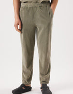 Vue de face du Pantalon en velours côtelé pour homme de couleur beige argile clair Argile Vintage, modèle Padow de la marque American Vintage. Présente une coupe droite ample d'inspiration jogging avec une taille élastiquée dotée d'un lien de resserrage et des poches italiennes.