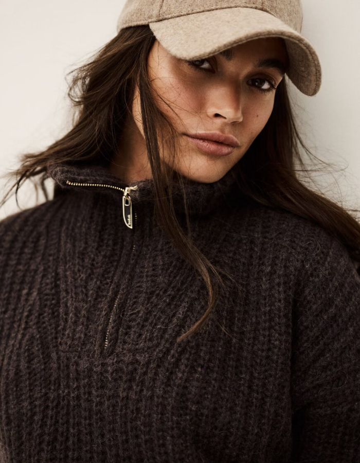 Col du Pull ample pour femme de couleur marron chocolat, modèle Beltane de la marque Ba&sh. Présente un col camionneur avec fermeture éclair métallique, des emmanchures tombantes basses, des manches longues et un tricotage texturé à côtes larges.