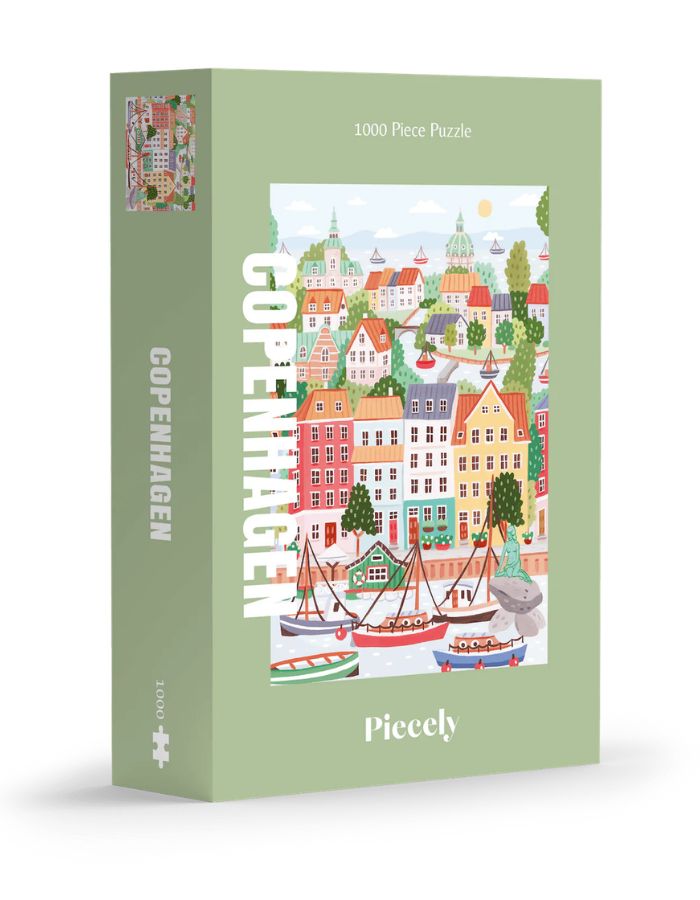 Puzzle de 1000 pièces pour adulte illustré par Serena White pour Piecely, représentant les canaux et les façades colorées de Copenhague au crépuscule. Présenté à côté de sa boîte de rangement élégante et écoresponsable.