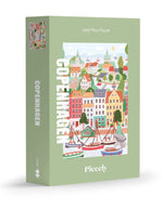 Puzzle de 1000 pièces pour adulte illustré par Serena White pour Piecely, représentant les canaux et les façades colorées de Copenhague au crépuscule. Présenté à côté de sa boîte de rangement élégante et écoresponsable.