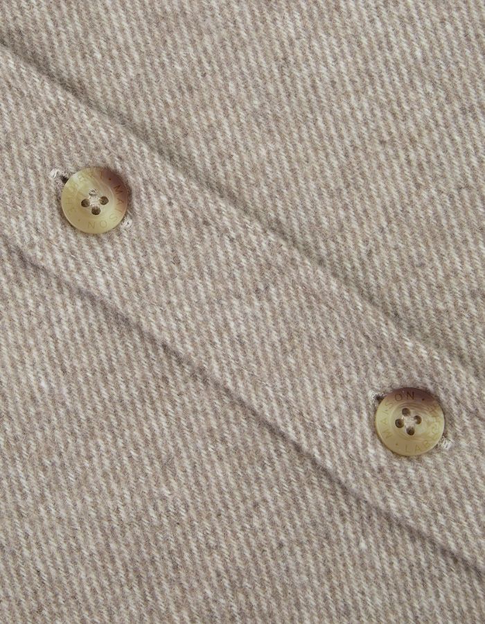 Boutons de la Surchemise ample en flanelle de laine mélangée gris ciment pour homme, modèle Monge de la marque Maison Labiche. Présente une coupe droite large avec col chemise, fermeture boutonnée et deux poches plaquées sur la poitrine.