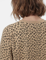 Dos du col du Sweatshirt à col rond et manches longues pour femme avec un imprimé léopard noir et marron sur fond blanc cassé, modèle Greta de la marque PIECES. Présente une broderie rouge vif en forme de cœur sur le côté gauche de la poitrine.