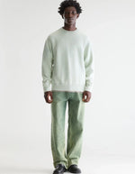 Man wearing a light aqua Bellerose FLAKE cotton sweatshirt with a round neck and regular fit.