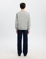 Silhouette de dos avec le Sweatshirt col rond pour homme en coton biologique gris clair chiné Light Grey Melange, modèle Relaxluke de la marque SELECTED HOMME. Présente une coupe droite avec finition en bord-côte au col, aux poignets et à la taille