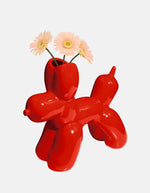 Fleurs roses dans le Vase en céramique rouge vif Bobby par la marque DOIY. Silhouette sculpturale aux lignes géométriques et découpes graphiques modernes, mesurant 25 cm de longueur.