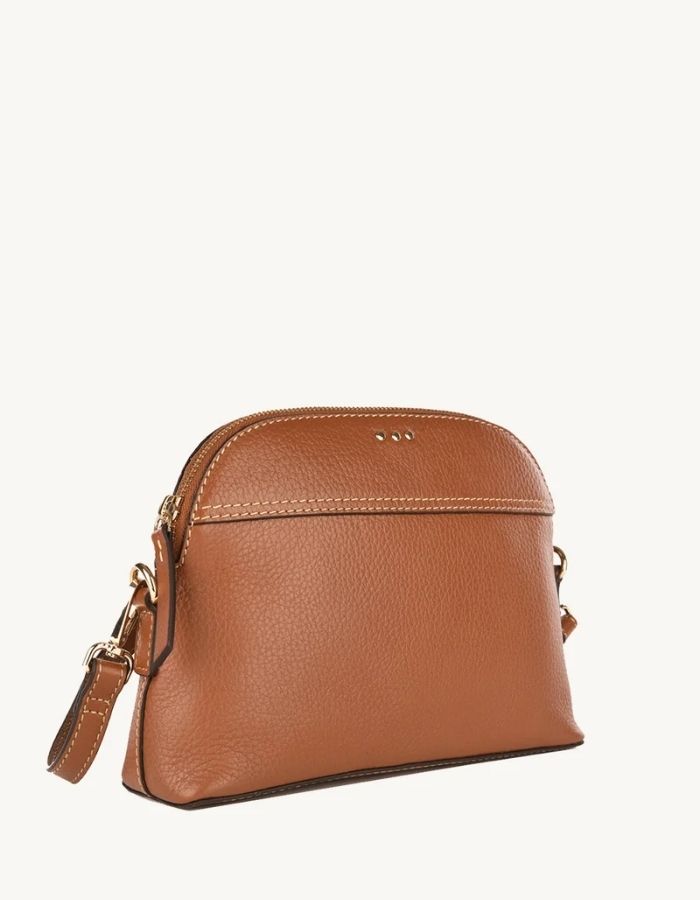 Profil du Petit sac bandoulière demi-lune pour femme en cuir grainé camel brandy avec fermeture zippée, modèle Demi-Lune de la marque Loxwood.