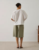 Blouse Issa Blanc Casse Soeur en coton biologique, coupe ample, col tombant, et ouverture boutonnée à l'épaule.