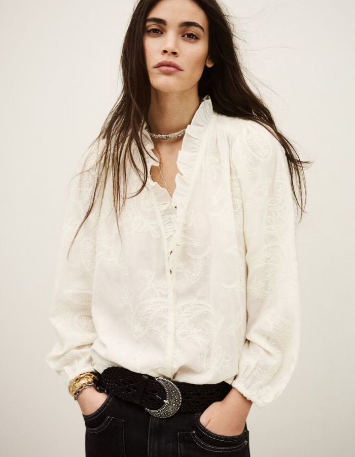 Blouse Petty Ecru ba&sh en jacquard texturé, col V à volants, portée par une femme.