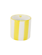 Bougie parfumée d'été Chichou de la marque Opjet, présentée dans un pot cylindrique en céramique blanche de 8 cm de hauteur avec des rayures horizontales jaunes peintes à la main