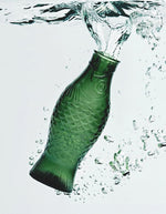 Ambiance avec la Carafe en verre pressé vert foncé sculptée en forme de poisson, design signé Paola Navone