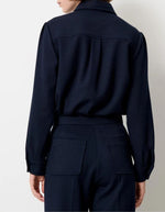 Dos de la Chemise courte pour femme en tricotine fluide bleu marine avec poches plaquées boutonnées et plis aux épaules, modèle Chemise Theodore couleur Navy de la marque Sessùn.