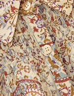 Tissu de la Chemise fluide à manches longues pour femme de couleur bleue à motifs imprimés, modèle Cleo de la marque Ba&sh. Présente une coupe droite ample avec fermeture boutonnée, des smocks élastiques décoratifs aux épaules et aux poignets terminés par un petit volant froncé