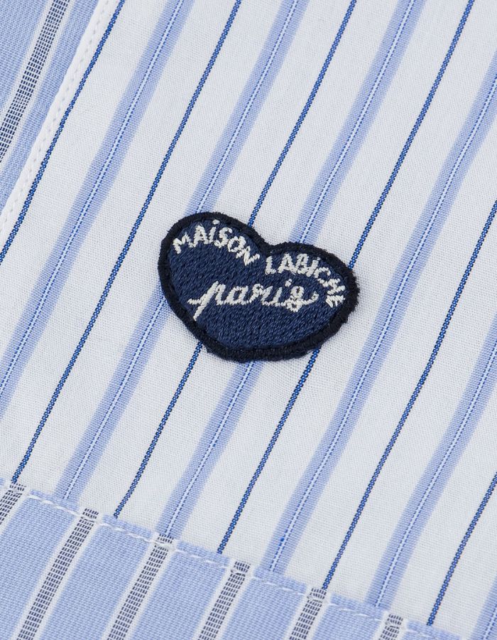Patch de la Chemise ample pour homme en popeline de coton à motifs patchwork, modèle Breteuil Patchwork de la marque Maison Labiche. Présente une coupe droite large avec col chemise, boutons gravés et une broderie discrète à l'arrière du col.