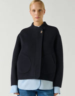 Devant du Manteau court pour femme en laine double face bleu marine profond Deep Navy, modèle Windsor de la marque SOEUR. Présente une coupe ample au volume rond, un col asymétrique, une patte de boutonnage semi-cachée et deux grandes poches plaquées sur le devant.