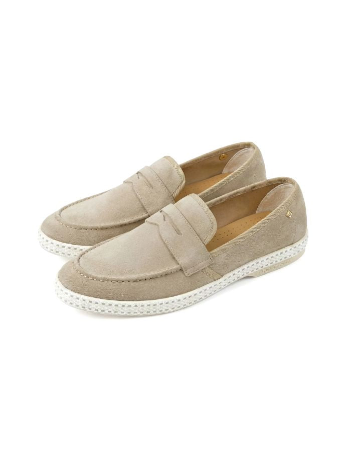 Paire de Mocassins Classic de la marque Rivieras, coloris beige. Tige en croûte de cuir de vachette, détails en ruban gros-grain et semelle blanche avec bande de coton. Fabriqués en Espagne.