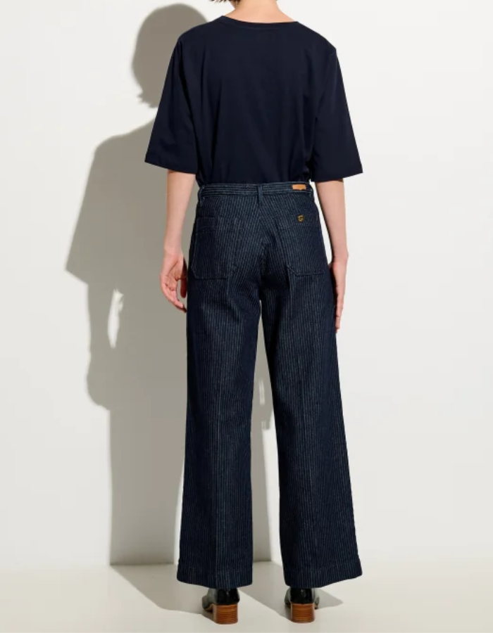 Dos du Pantalon droit taille haute pour femme en denim bleu indigo à fines rayures coutil avec plis marqués le long de la jambe, modèle Pantalon Aldricks couleur Blootil de la marque Sessùn.