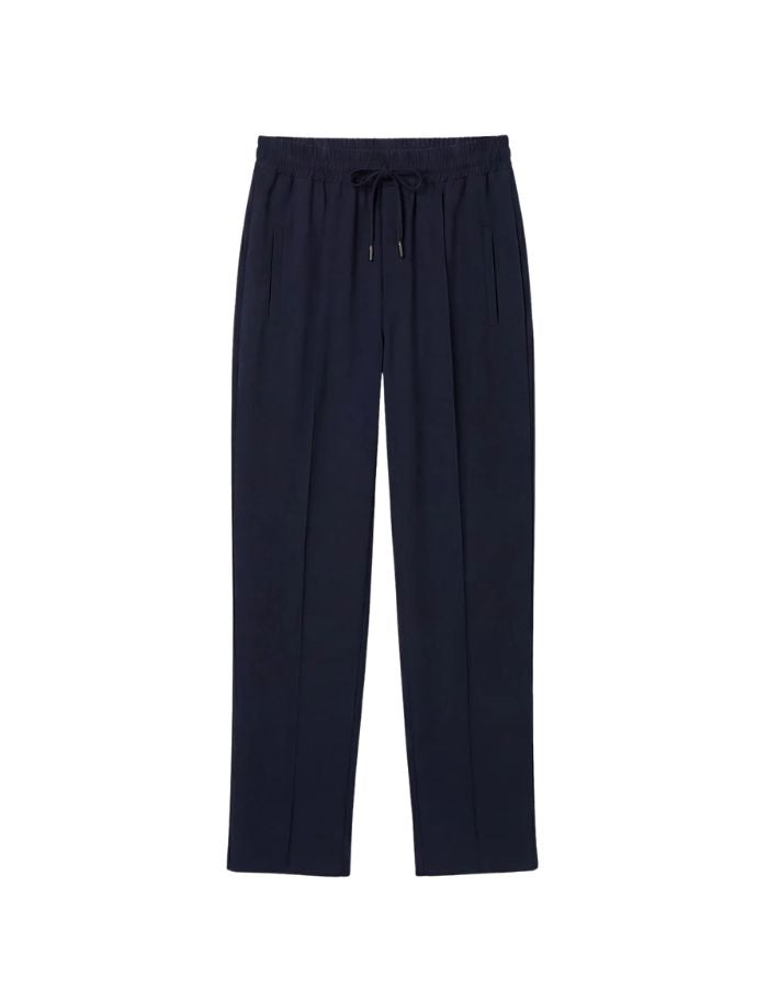 Pantalon large pour femme en flanelle bleu nuit, modèle Oliver de la marque Hana San. Présente une taille élastiquée avec cordon à nouer, des poches latérales et des nervures structurantes sur le devant.