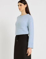 Profil du Pull pour femme en baby alpaga bleu ciel à coupe boîte, col rond et poche poitrine côtelée, modèle Ben de la marque Hana San