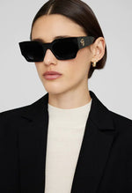 Solaires Indio Monogram Black Anine Bing: monture carrée oversized en acétate noir, monogramme AB doré.
